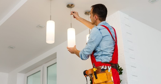 man working on electrical lights