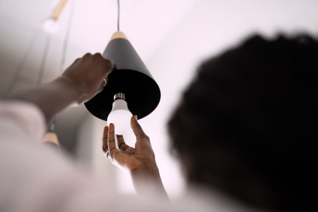 Man Screwing in LED Lightbulb